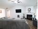 Living room with vaulted ceilings, wood floors, gray sectional sofa and a fireplace at 550 Sessingham Ct, Alpharetta, GA 30005