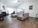 Spacious living room with hardwood floors, a fireplace and a comfortable gray sectional sofa at 550 Sessingham Ct, Alpharetta, GA 30005