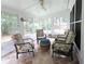 Cozy sun room with tiled flooring, large windows, and comfortable seating at 550 Sessingham Ct, Alpharetta, GA 30005