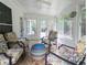 Bright sunroom with lots of natural light and comfortable seating for relaxing at 550 Sessingham Ct, Alpharetta, GA 30005