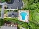 Aerial view featuring a sparkling pool with lounge chairs, surrounded by lush landscaping, parking and trees at 603 Brighton Pt, Atlanta, GA 30328