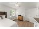 Bedroom with a large window for natural light, wood-look floors, and an area rug at 603 Brighton Pt, Atlanta, GA 30328