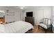 Bedroom with hardwood floors, ceiling fan, closet, and television mounted to wall at 603 Brighton Pt, Atlanta, GA 30328
