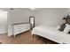 Comfortable bedroom featuring a bed, a dresser, and hardwood style floors at 603 Brighton Pt, Atlanta, GA 30328