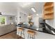 Open kitchen with black countertops, breakfast bar, and modern appliances at 603 Brighton Pt, Atlanta, GA 30328