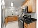 Efficient kitchen with granite countertops, wooden cabinets, and stainless steel appliances at 603 Brighton Pt, Atlanta, GA 30328