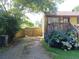 Fenced backyard with a wooden gate, lush greenery, and a charming deck area at 649 Mary Ln, Marietta, GA 30062