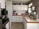 Cozy kitchen with white cabinets, a tile backsplash, and ample countertop space at 649 Mary Ln, Marietta, GA 30062