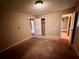 Bedroom with a closet and attached bath, carpeted flooring, and neutral walls, ready for personalization at 718 Hardy Way, Hiram, GA 30141