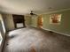 Living room with a brick fireplace, large window, and neutral-toned carpet, showing an open floor plan at 718 Hardy Way, Hiram, GA 30141