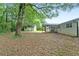 Expansive backyard featuring a screened-in porch and a detached shed, perfect for outdoor activities at 1694 Pheasant Dr, Atlanta, GA 30238