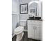 This half bathroom offers black counter tops, gray walls, and black wood look floor tiles at 1694 Pheasant Dr, Atlanta, GA 30238