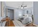 A stylish bedroom featuring a ceiling fan, wood floors, and a cozy queen-size bed at 1694 Pheasant Dr, Atlanta, GA 30238