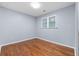 A well lit bedroom with hardwood flooring and window to the outside at 1694 Pheasant Dr, Atlanta, GA 30238