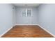 A bright bedroom with hardwood flooring and a double window letting in plenty of natural light at 1694 Pheasant Dr, Atlanta, GA 30238
