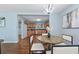 A dining area with hardwood floors, a dark wood table, and a view into the kitchen at 1694 Pheasant Dr, Atlanta, GA 30238