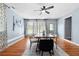 Bright dining room with a long table, a modern ceiling fan, and natural light at 1694 Pheasant Dr, Atlanta, GA 30238