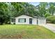 Charming white-brick home with a well-manicured lawn and a bright blue front door at 1694 Pheasant Dr, Atlanta, GA 30238