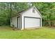 This detached garage features a large door for vehicles and an additional side door at 1694 Pheasant Dr, Atlanta, GA 30238