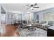 A living room with hardwood floors, two sofas, and a view into a dining area at 1694 Pheasant Dr, Atlanta, GA 30238