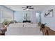 Inviting living room with a plush gray sofa, a ceiling fan, and a light blue wall at 1694 Pheasant Dr, Atlanta, GA 30238