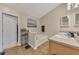Well-lit bathroom with a soaking tub, double sinks, and a separate toilet area at 2083 Hasel St, Lawrenceville, GA 30044