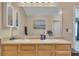 Bathroom featuring a double sink vanity, large mirror, and wood cabinets at 2083 Hasel St, Lawrenceville, GA 30044