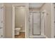 Bathroom features a toilet, and a glass shower enclosure at 2083 Hasel St, Lawrenceville, GA 30044
