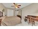 This bedroom features neutral walls, carpet, a ceiling fan, and a dark wood desk at 2083 Hasel St, Lawrenceville, GA 30044