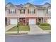 Charming townhomes featuring stone accents, individual garages and beautifully maintained lawns at 2083 Hasel St, Lawrenceville, GA 30044