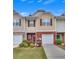 Inviting townhome with brick facade, tidy landscaping, and private garage at 2083 Hasel St, Lawrenceville, GA 30044