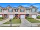 Attractive townhome exteriors include individual garages, mature landscaping, and concrete driveways at 2083 Hasel St, Lawrenceville, GA 30044