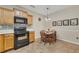 This open kitchen shows the oven, tile floors, cabinets, and an attached dining area at 2083 Hasel St, Lawrenceville, GA 30044