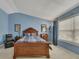 Comfortable main bedroom features blue walls, vaulted ceiling, and natural light at 2083 Hasel St, Lawrenceville, GA 30044