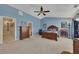 Expansive main bedroom boasts a tray ceiling, ceiling fan, and neutral carpet at 2083 Hasel St, Lawrenceville, GA 30044