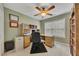 This home office features a ceiling fan, a window, built-in shelving, and a desk area at 2083 Hasel St, Lawrenceville, GA 30044