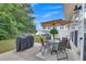 Patio area featuring an umbrella, a glass-topped table and seating, and a grill at 2083 Hasel St, Lawrenceville, GA 30044