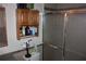 Bathroom featuring updated shower with glass doors, oak cabinet and toilet at 2697 Vinings Central Dr # 61, Atlanta, GA 30339
