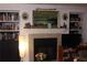 Living room featuring a fireplace, mantle with decor, shelves, and a tv at 2697 Vinings Central Dr # 61, Atlanta, GA 30339