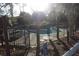 Community pool with a black metal fence and a patio with table and umbrella at 2697 Vinings Central Dr # 61, Atlanta, GA 30339