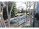 Exterior view of a community tennis court with bare trees and black chain link fence at 2697 Vinings Central Dr # 61, Atlanta, GA 30339