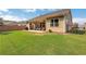 View of the spacious backyard with covered porch, well-maintained lawn, and privacy fencing at 2980 Prestwood Dr, Cumming, GA 30040