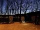 A beautifully lit backyard at dusk showcases a tranquil outdoor space and manicured landscaping at 2980 Prestwood Dr, Cumming, GA 30040