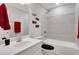 Well-lit bathroom with a shower-tub combination and stylish red accents at 2980 Prestwood Dr, Cumming, GA 30040