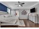 This bedroom includes a ceiling fan, an ensuite bath with barn door, and hardwood floors at 2980 Prestwood Dr, Cumming, GA 30040