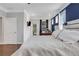 A bright bedroom with hardwood floors features a door to the backyard and work space at 2980 Prestwood Dr, Cumming, GA 30040