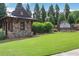 Charming stone entrance to the Mountain Crest community with beautiful landscaping at 2980 Prestwood Dr, Cumming, GA 30040