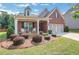Inviting front porch with chairs and beautiful landscaping adds curb appeal at 2980 Prestwood Dr, Cumming, GA 30040