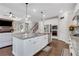 Open kitchen with a granite island, stainless steel appliances, and seamless flow into the living room area at 2980 Prestwood Dr, Cumming, GA 30040