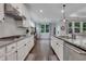 Spacious kitchen with stainless steel appliances, granite countertops, and a view into the adjacent living area at 2980 Prestwood Dr, Cumming, GA 30040